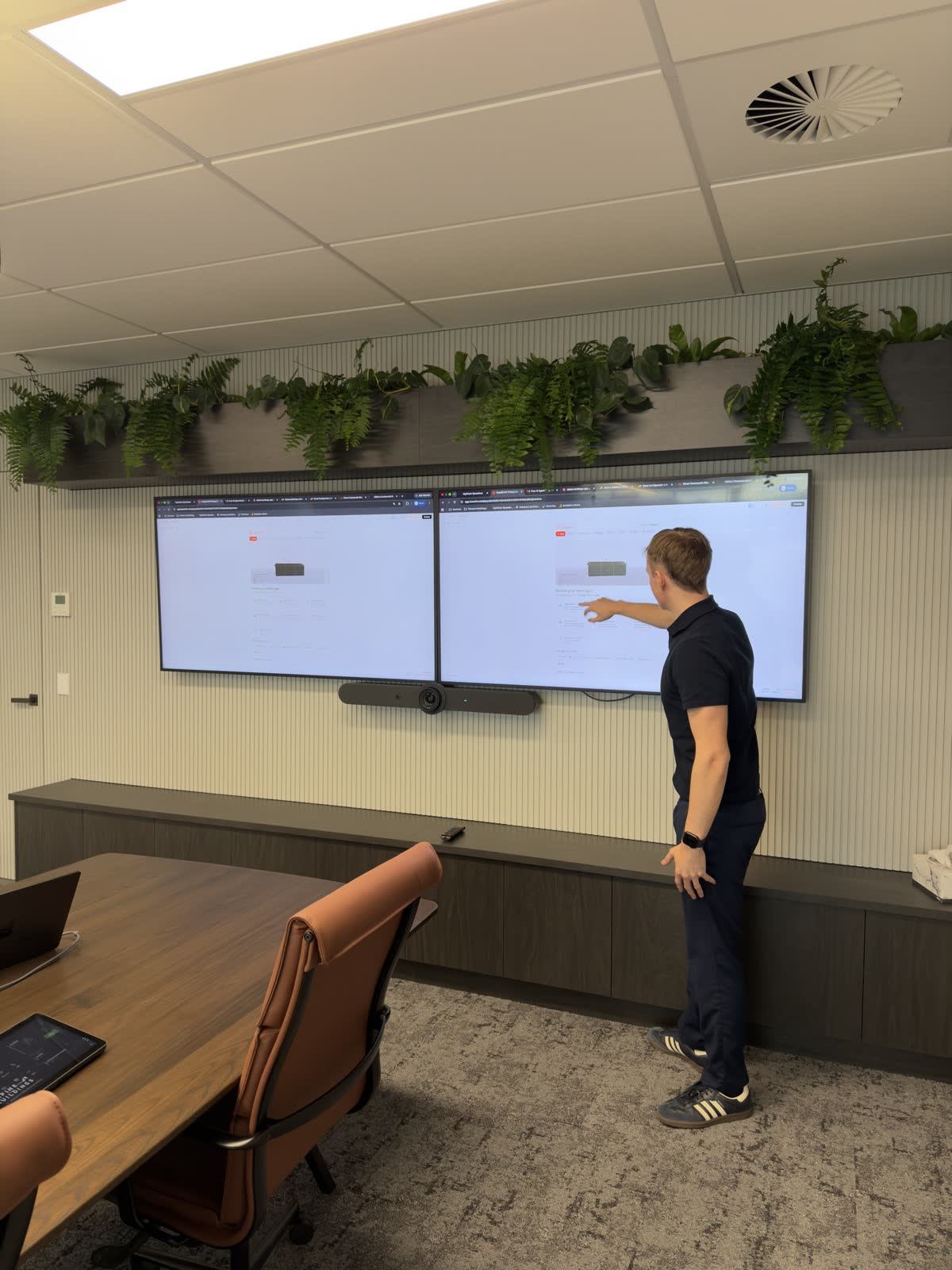 HighPeak consultant walking through a digital workflow at a meeting-room screen